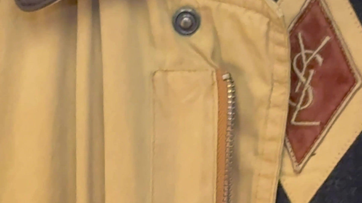 Leather brand lozenge, snap fastener and zip on a vintage jacket, the details authentication depends on