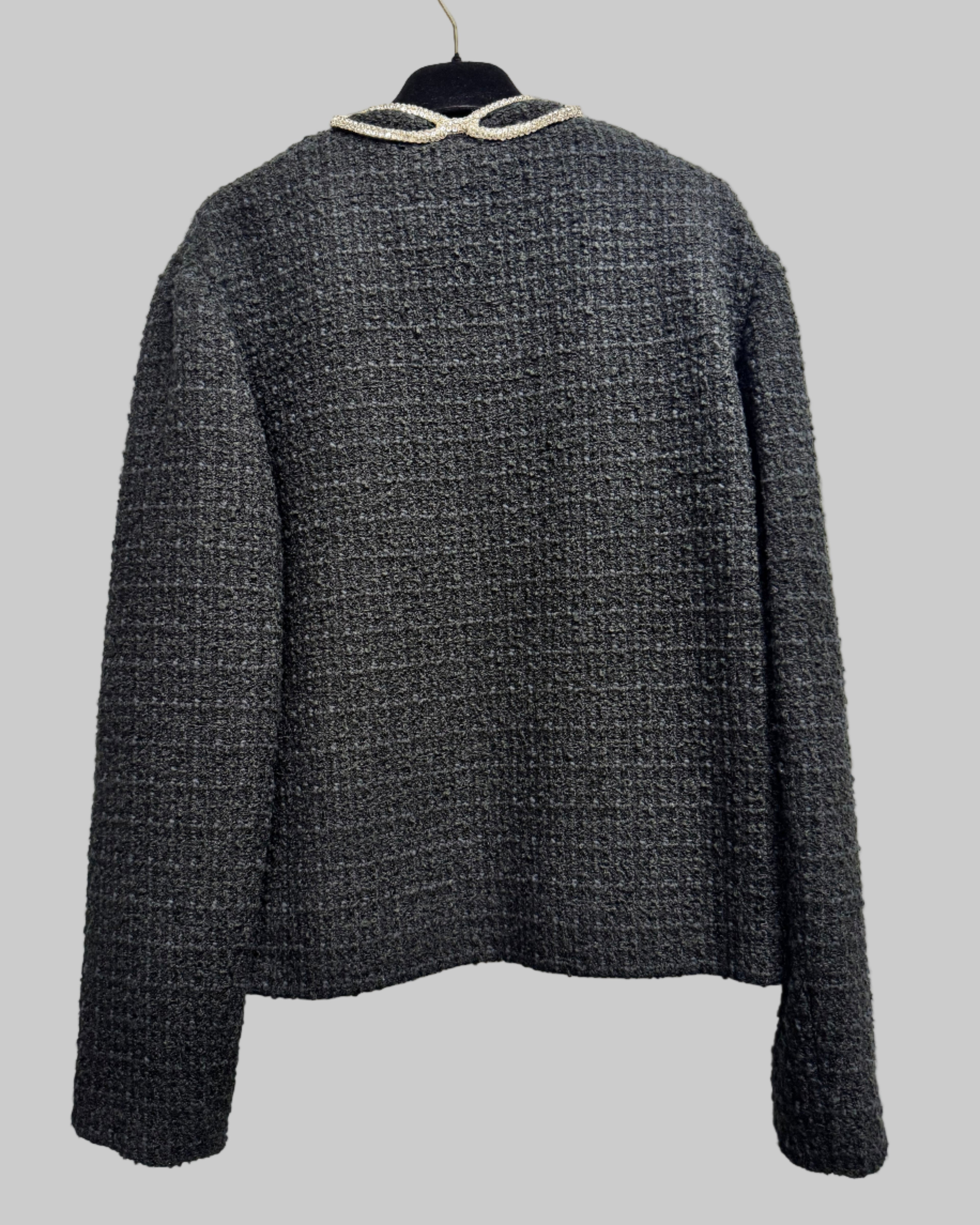 Dark gray textured jacket on a white surface