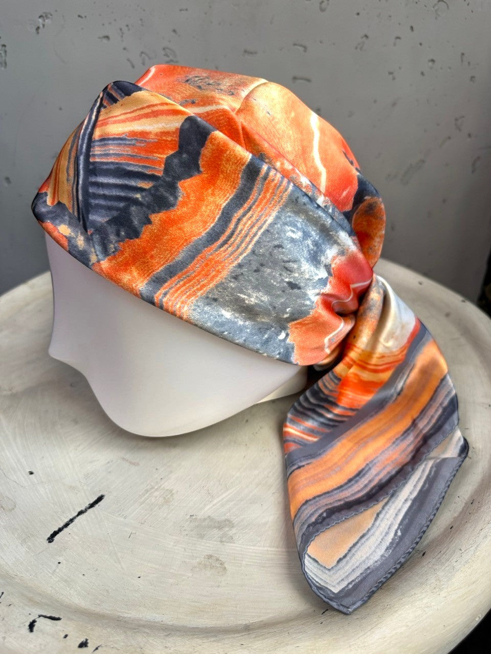 BERLIN VINTAGE CORNER abstract print silk scarf in burnt orange, charcoal, and cream with a geode-inspired pattern.