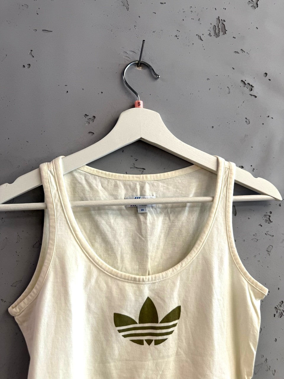 BERLIN VINTAGE CORNER cream cotton Adidas tank top with olive green trefoil logo. Sleeveless with scoop neck.