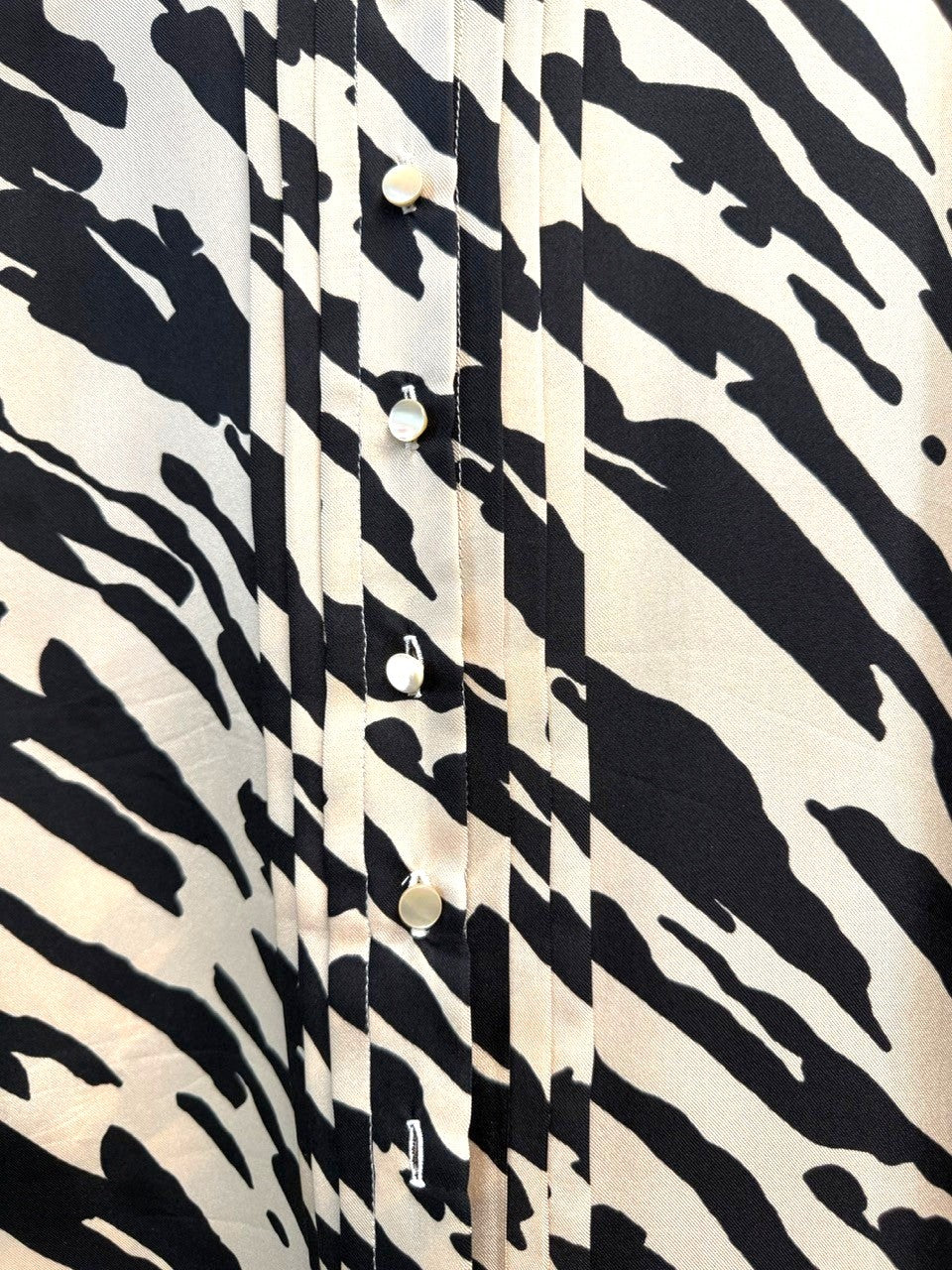 BERLIN VINTAGE CORNER black and beige animal print sleeveless silk blend blouse with pintuck detailing and pearl buttons.