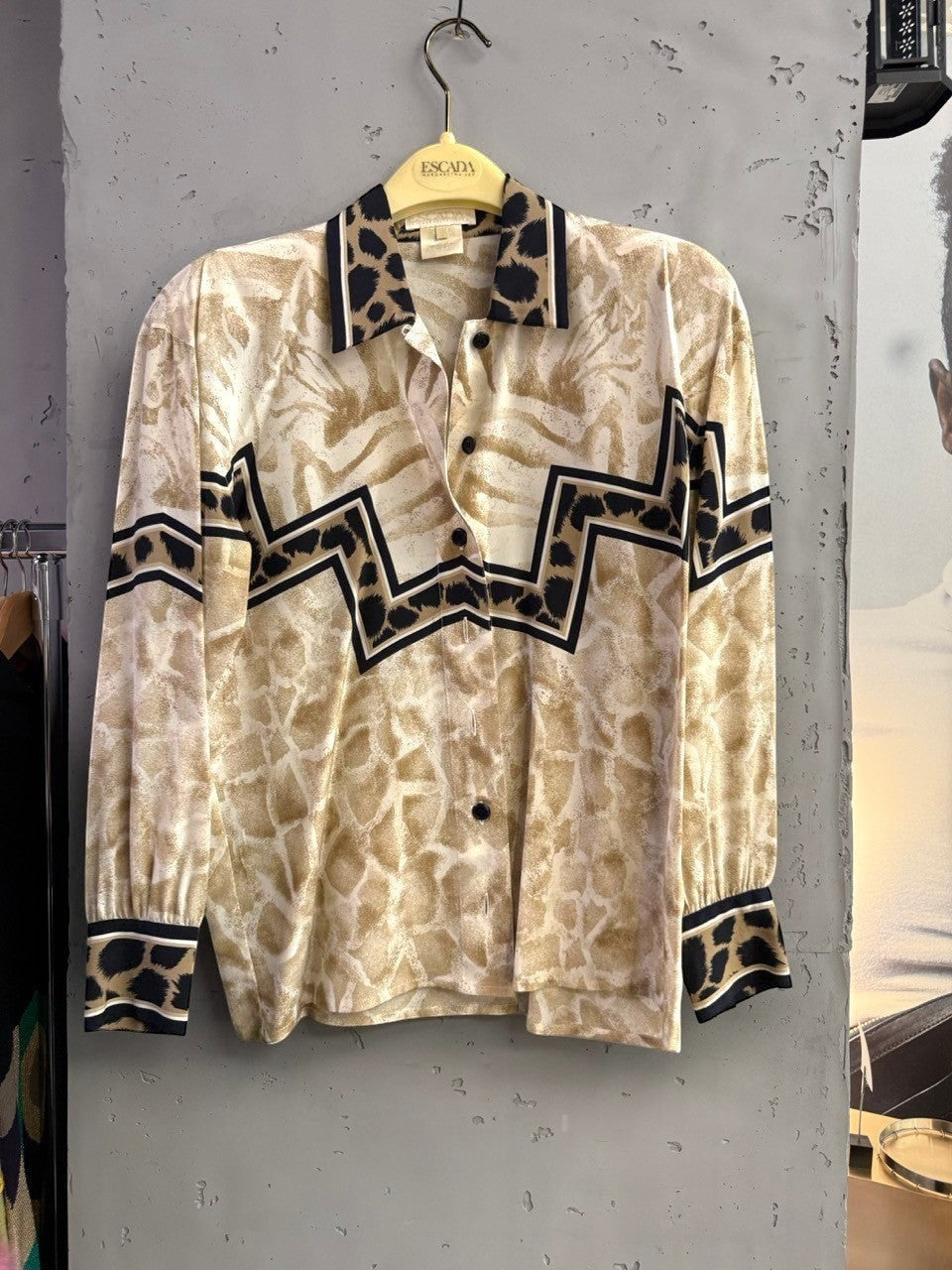 BERLIN VINTAGE CORNER long-sleeved button-up blouse with abstract animal print, black and tan trim, and zig-zag pattern.