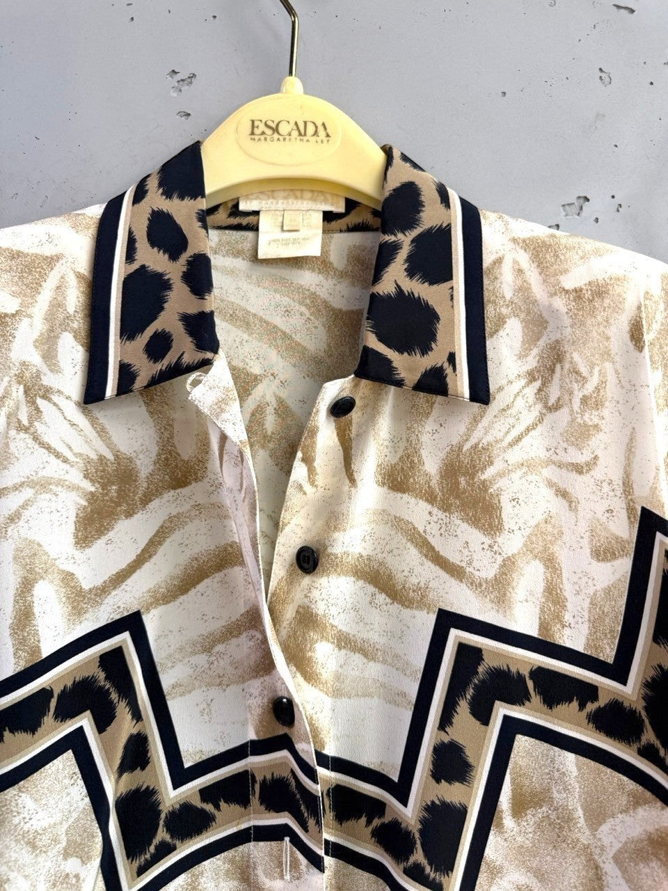 BERLIN VINTAGE CORNER animal print button-up shirt with black and tan trim and abstract zebra and giraffe patterns.