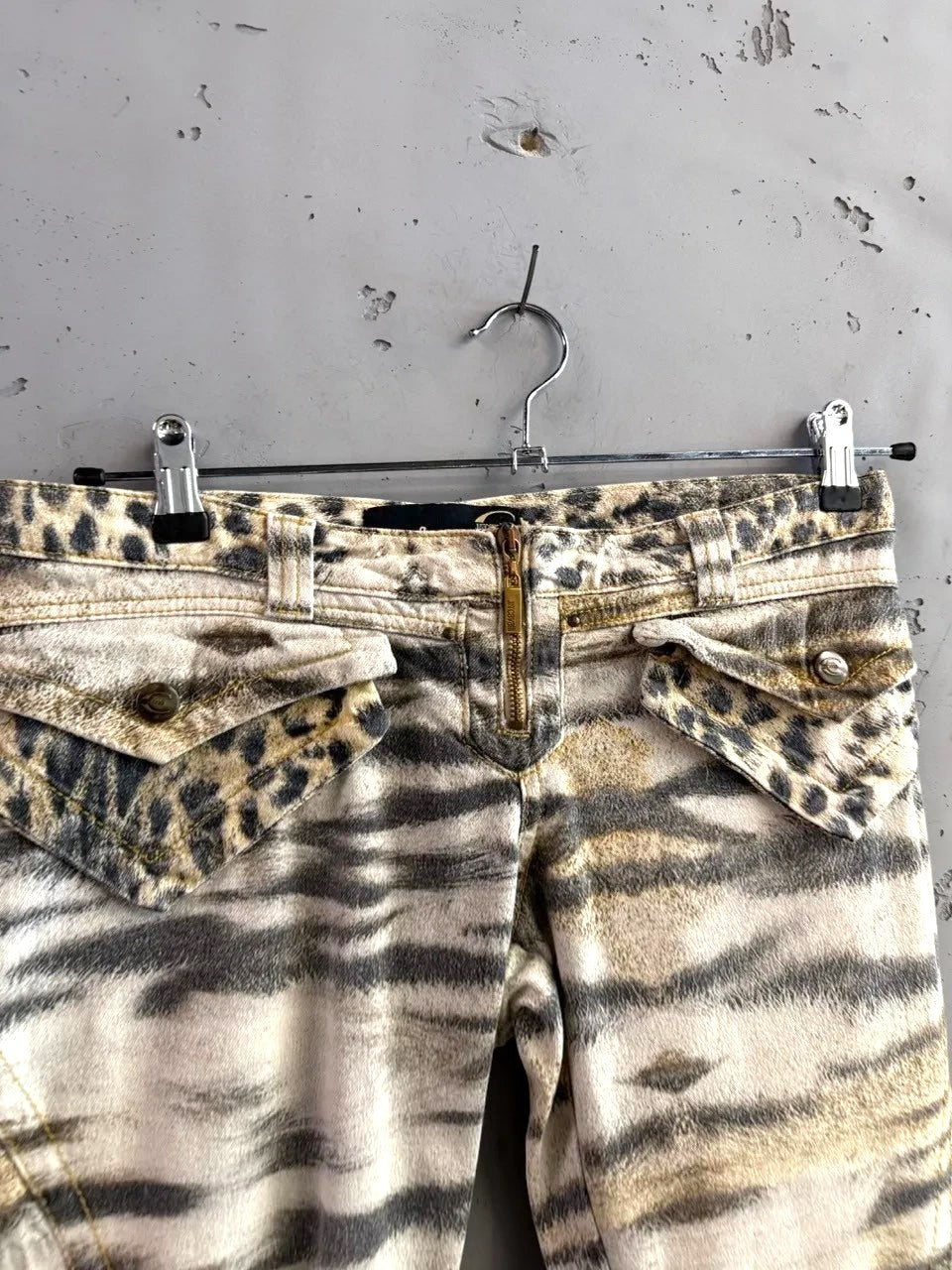 BERLIN VINTAGE CORNER animal print cargo capri pants with tiger and leopard patterns, zip fly, button pockets, and belt.