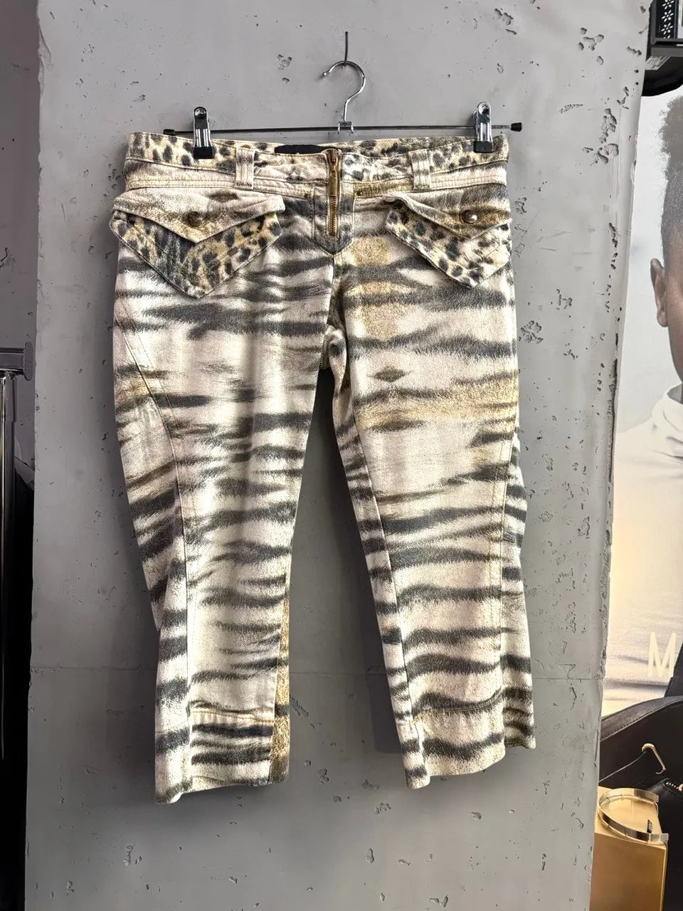 BERLIN VINTAGE CORNER animal print cargo capri pants with belt, featuring tiger and leopard patterns, zip fly, and flap pockets.