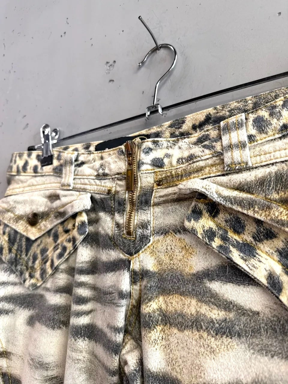 BERLIN VINTAGE CORNER animal print cargo pants with belt, featuring tiger and leopard spots, zip fly, and flap pockets.