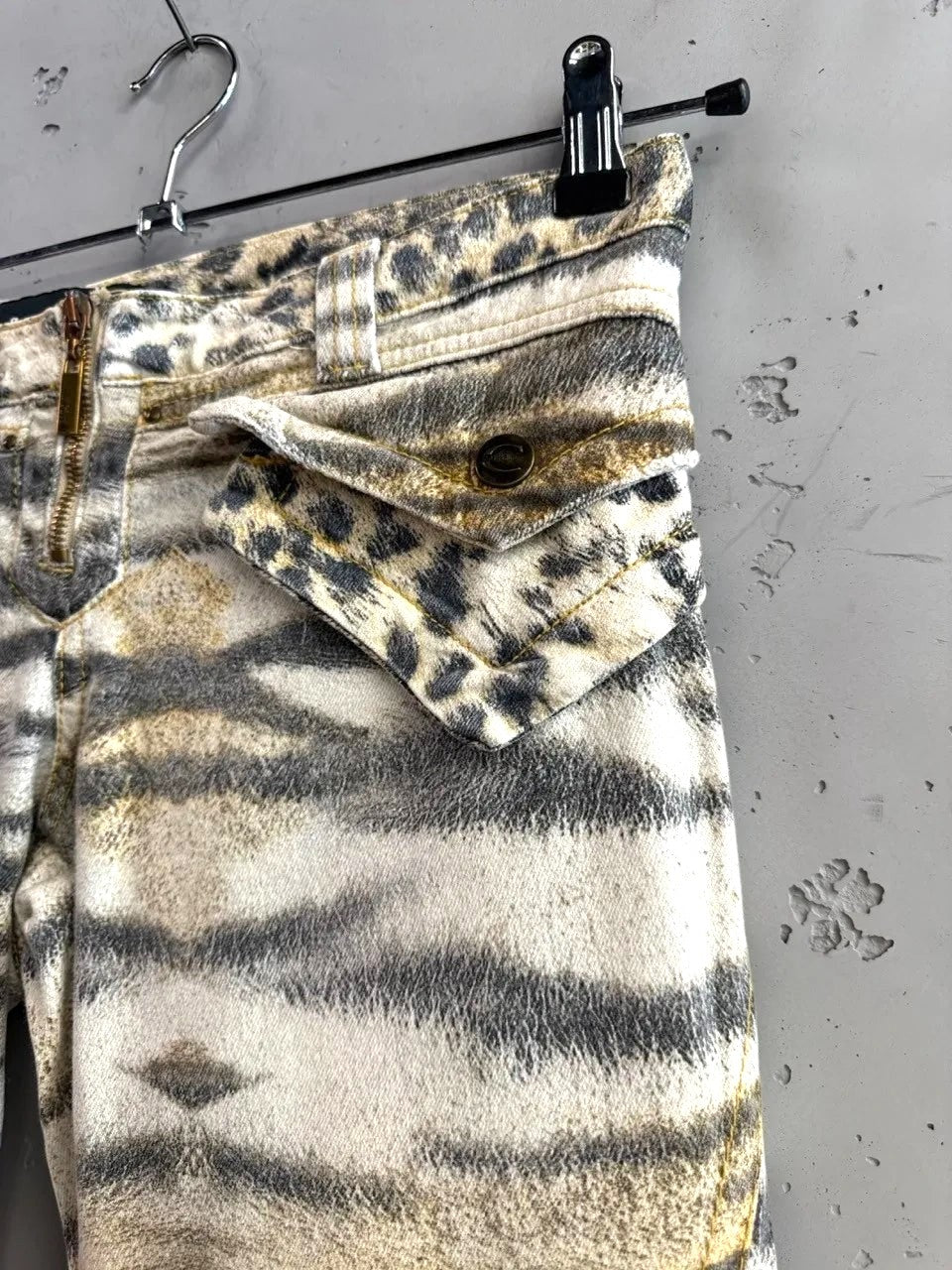 BERLIN VINTAGE CORNER animal print cargo capri pants with tiger and leopard spots, zip fly, button pockets, and belt.