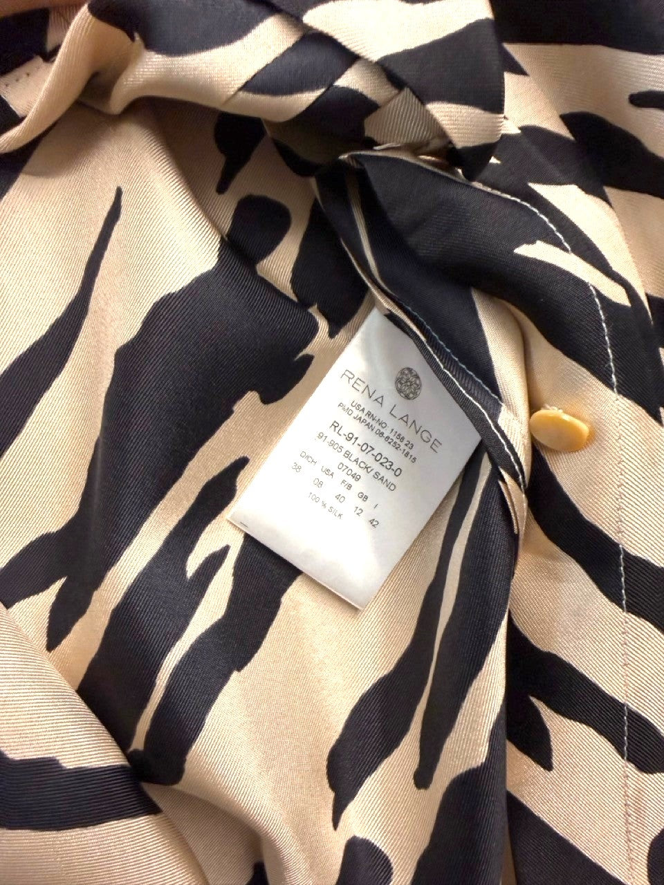 BERLIN VINTAGE CORNER sleeveless black and beige animal print silk blend blouse with pintuck detailing.