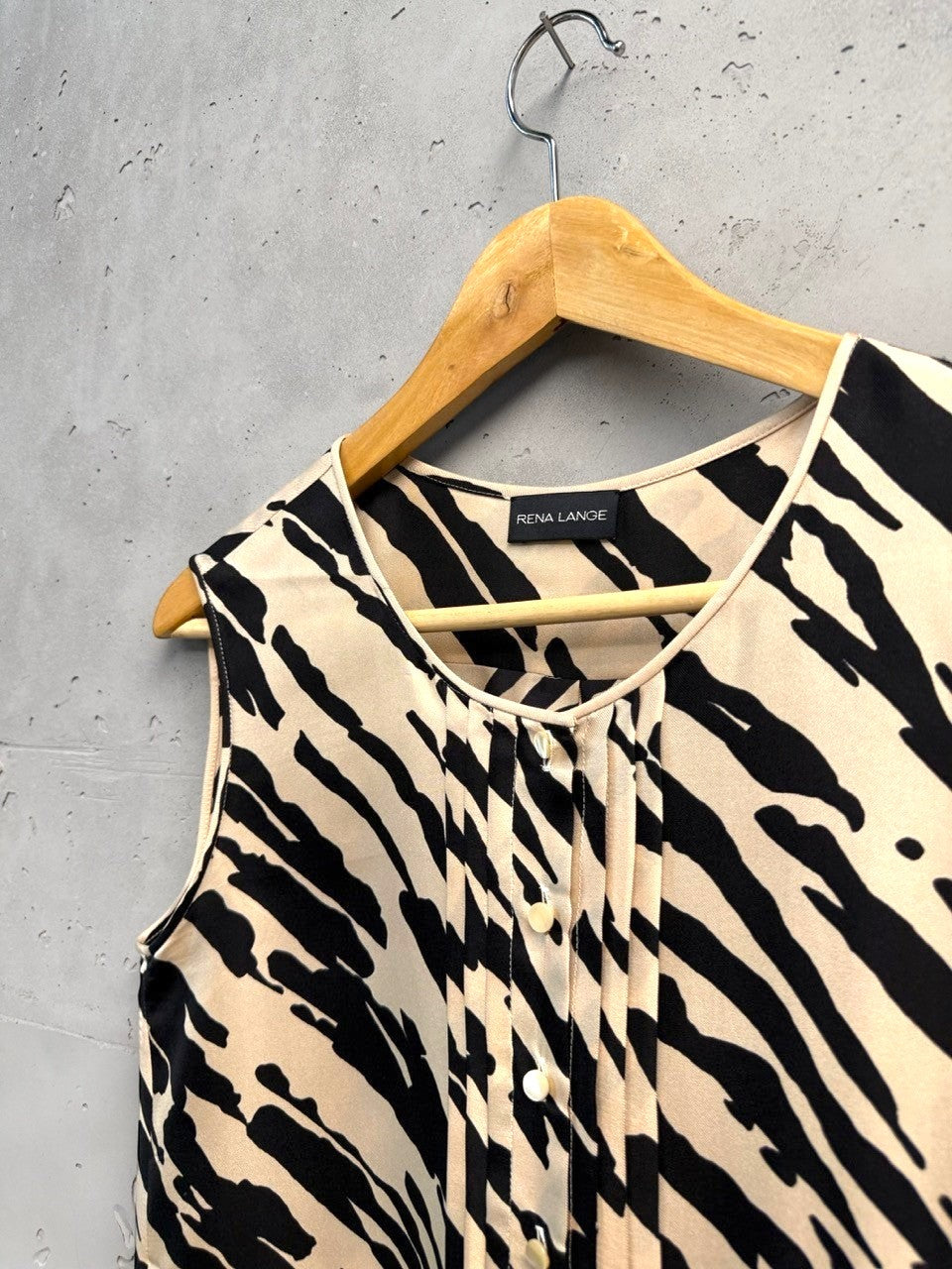 BERLIN VINTAGE CORNER sleeveless beige and black animal print silk blend blouse with pintuck detailing and button front.