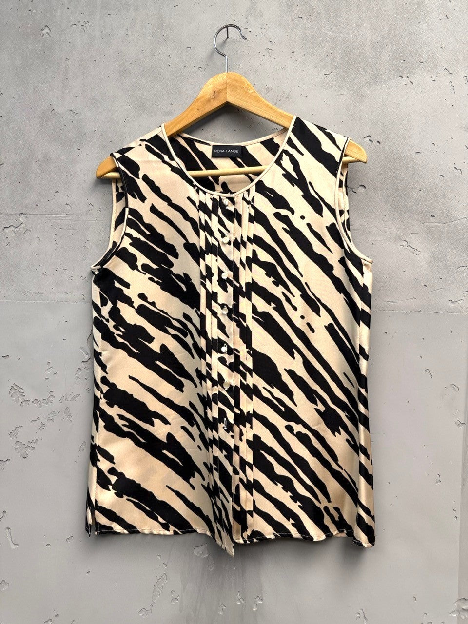 BERLIN VINTAGE CORNER sleeveless black and beige animal print silk blend blouse with pintuck detailing.