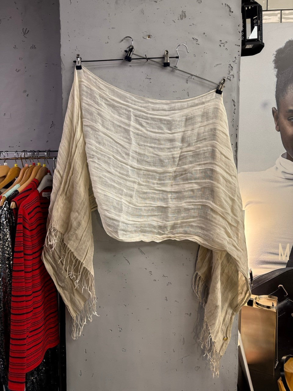 BERLIN VINTAGE CORNER Armani Collezioni cream linen scarf with textured weave and fringe edges hanging on a rack.