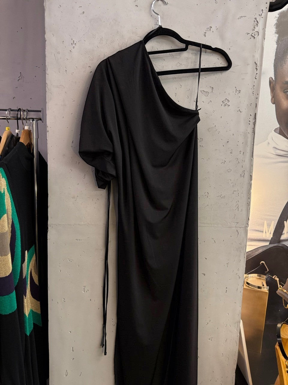 BERLIN VINTAGE CORNER Balmain black one-shoulder midi dress with ruched sleeve detail hanging on a rack
