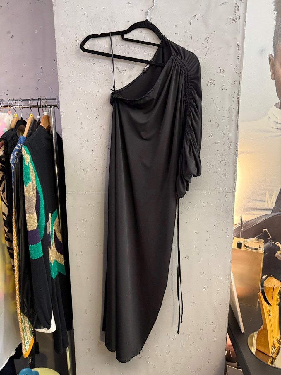 BERLIN VINTAGE CORNER black Balmain one-shoulder midi dress with ruched sleeve detail hanging on a rack