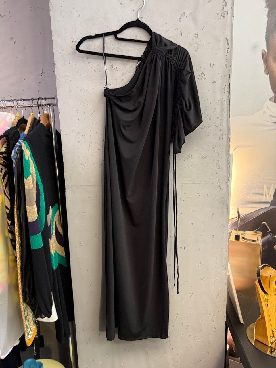 BERLIN VINTAGE CORNER black Balmain one-shoulder midi dress with ruched sleeve detail hanging on a rack