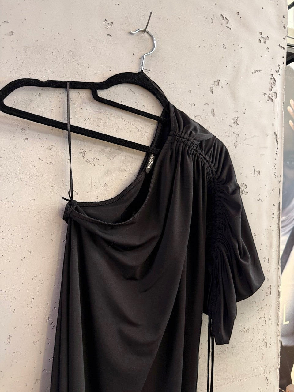 BERLIN VINTAGE CORNER black Balmain one-shoulder midi dress with ruched sleeve detail hanging on a black hanger
