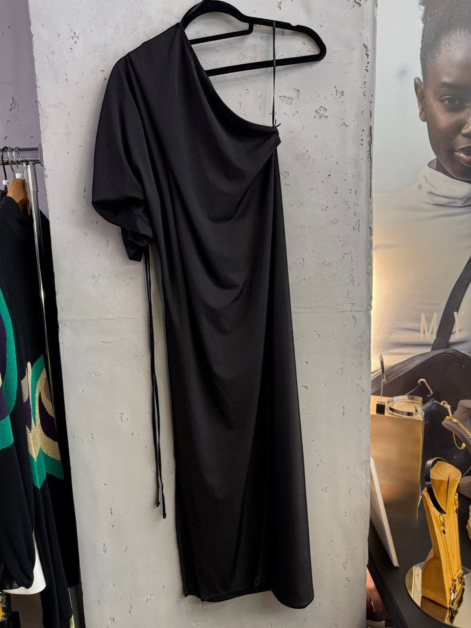 BERLIN VINTAGE CORNER black BALMAIN PARIS one-shoulder midi dress with ruched sleeve detail hanging on a display rack.