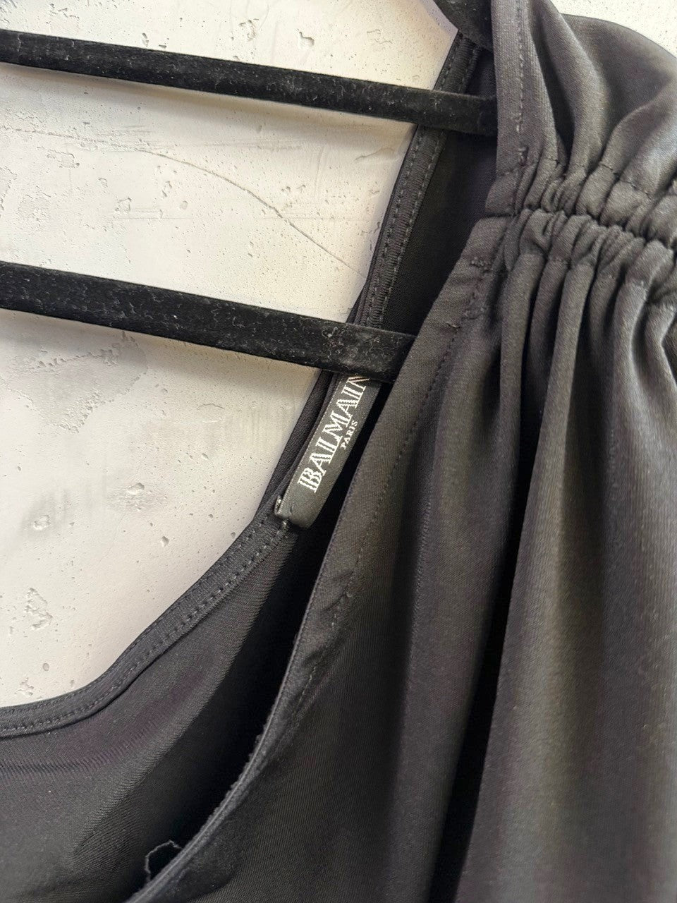BERLIN VINTAGE CORNER Balmain black one-shoulder midi dress with ruched sleeve detail on a hanger