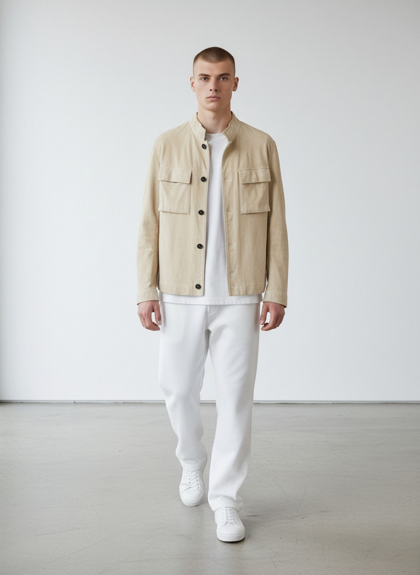 BERLIN VINTAGE CORNER beige suede safari jacket with band collar, two chest pockets, and button-down front.