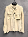 BERLIN VINTAGE CORNER beige suede safari jacket with band collar and two chest pockets.