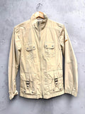 BERLIN VINTAGE CORNER beige lightweight utility jacket with multiple cargo pockets, stand-up collar, and zip closure.