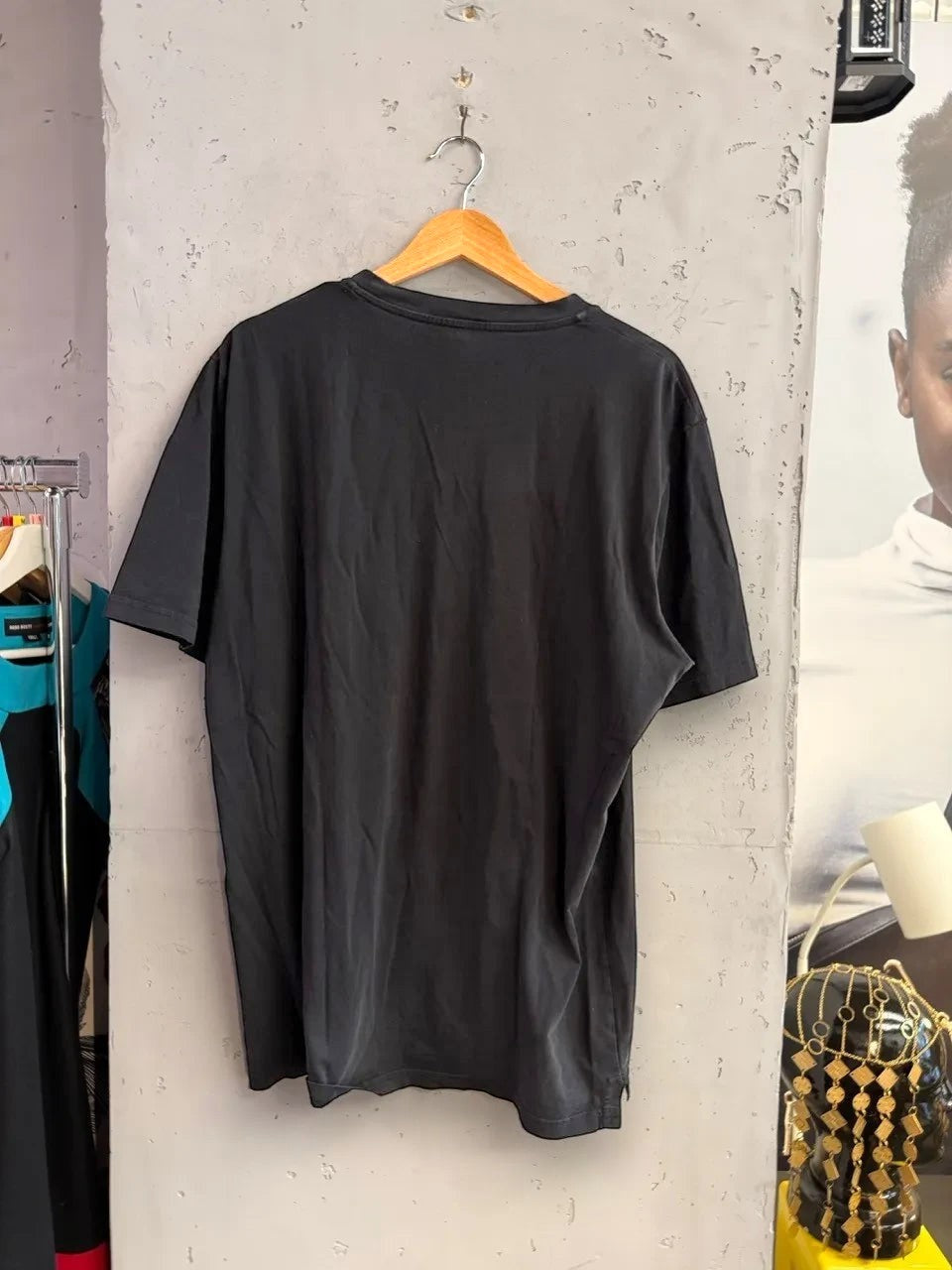 Back view of a plain black Just Cavalli cotton crewneck t-shirt hanging on a wooden hanger at BERLIN VINTAGE CORNER.