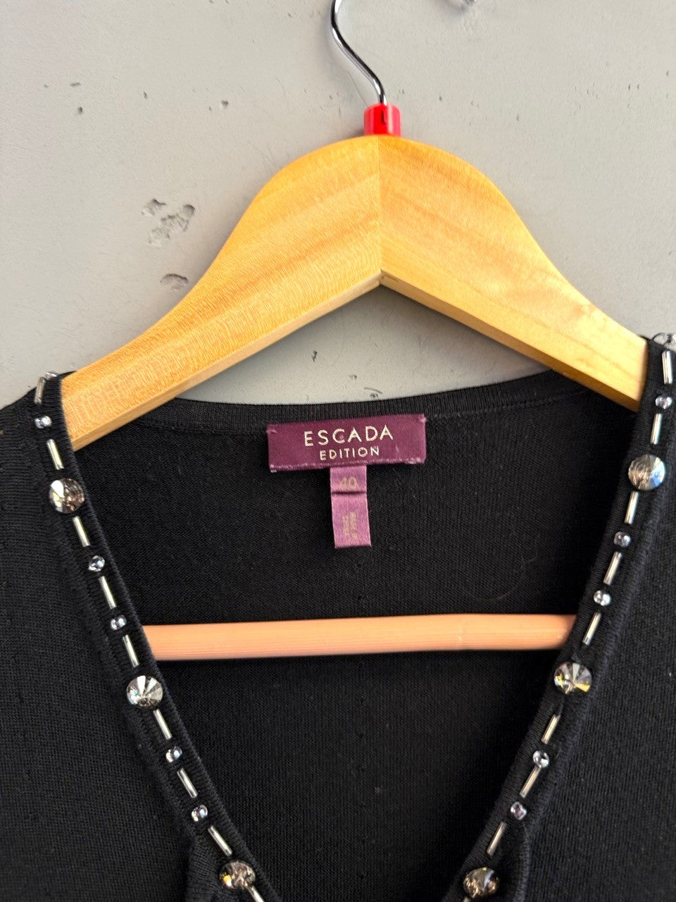 BERLIN VINTAGE CORNER black sleeveless knit V-neck top with crystal and bead embellishments.