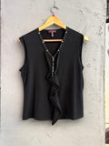 BERLIN VINTAGE CORNER black sleeveless knit V-neck top with crystal and bead embellishments and ruffled front.