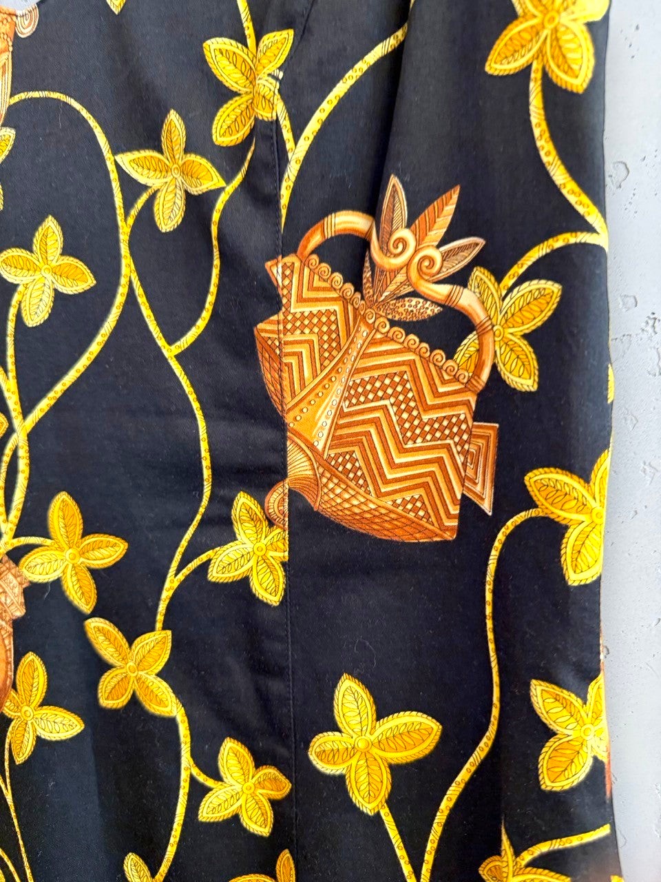 BERLIN VINTAGE CORNER black mini dress with gold and brown tribal floral print, V-neck, sleeveless.