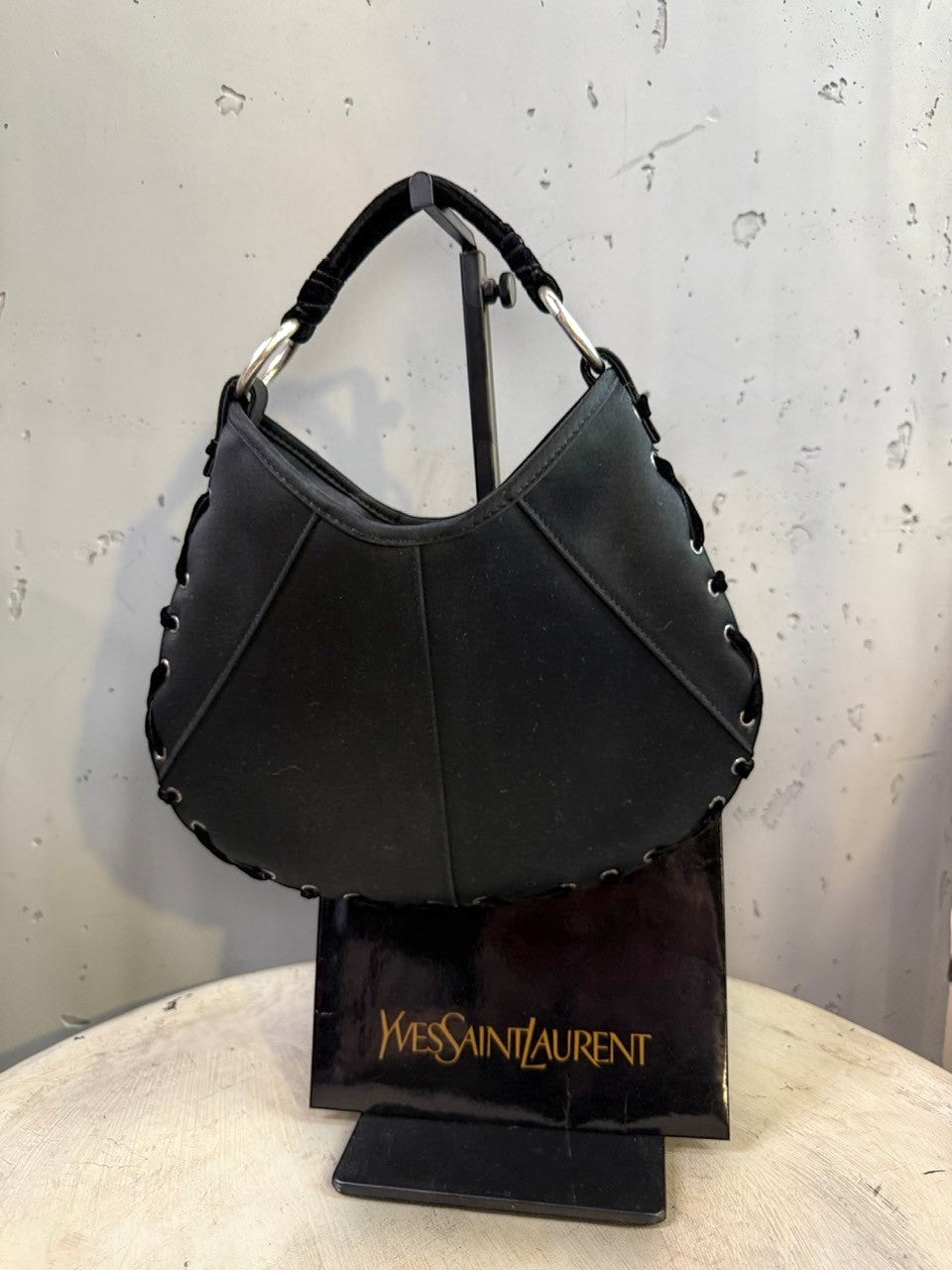 BERLIN VINTAGE CORNER black hobo shoulder bag with crescent moon shape, velvet strap, and lacing detail.