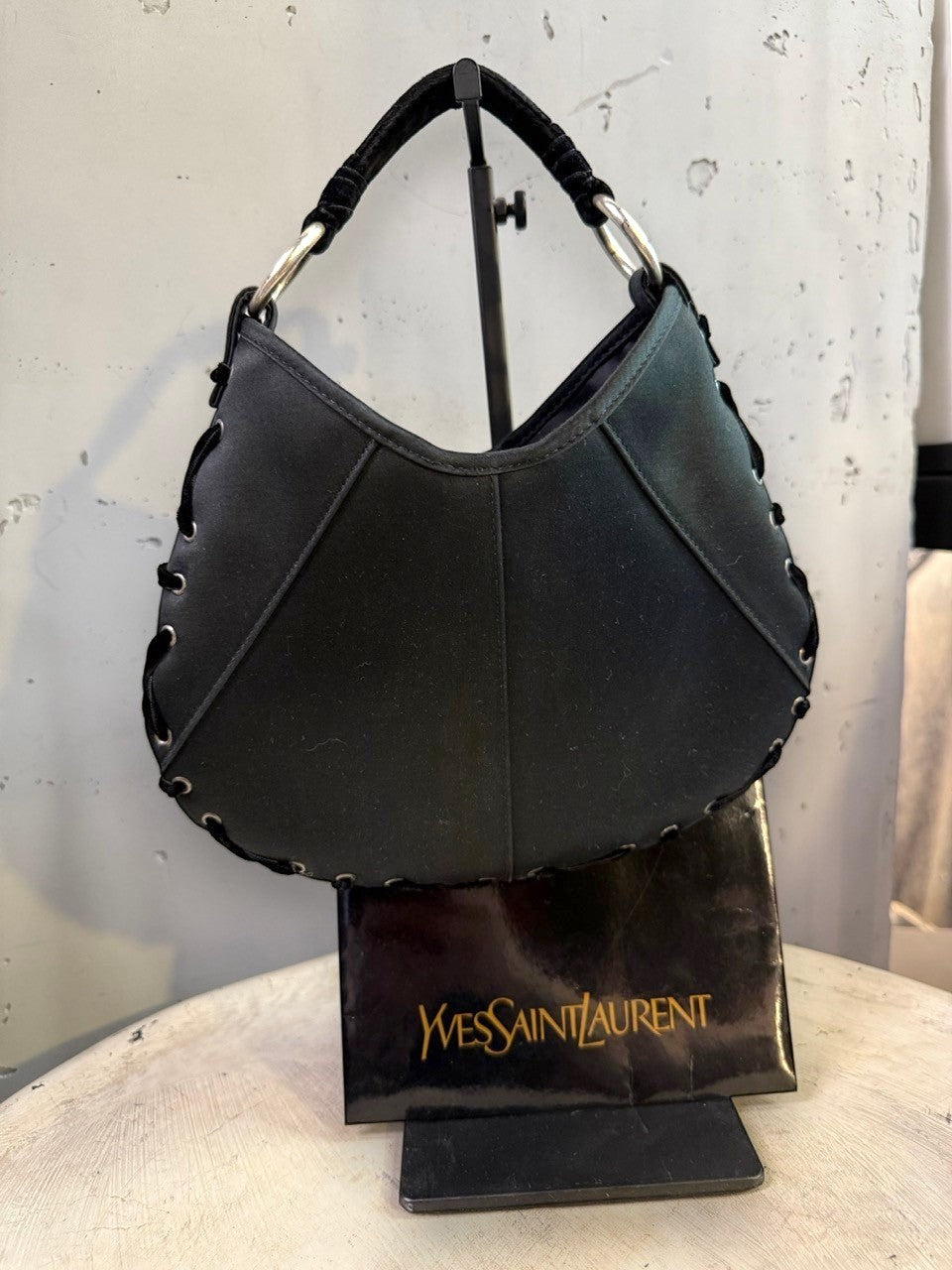 BERLIN VINTAGE CORNER black hobo shoulder bag with crescent moon shape, velvet strap, and lacing detail.