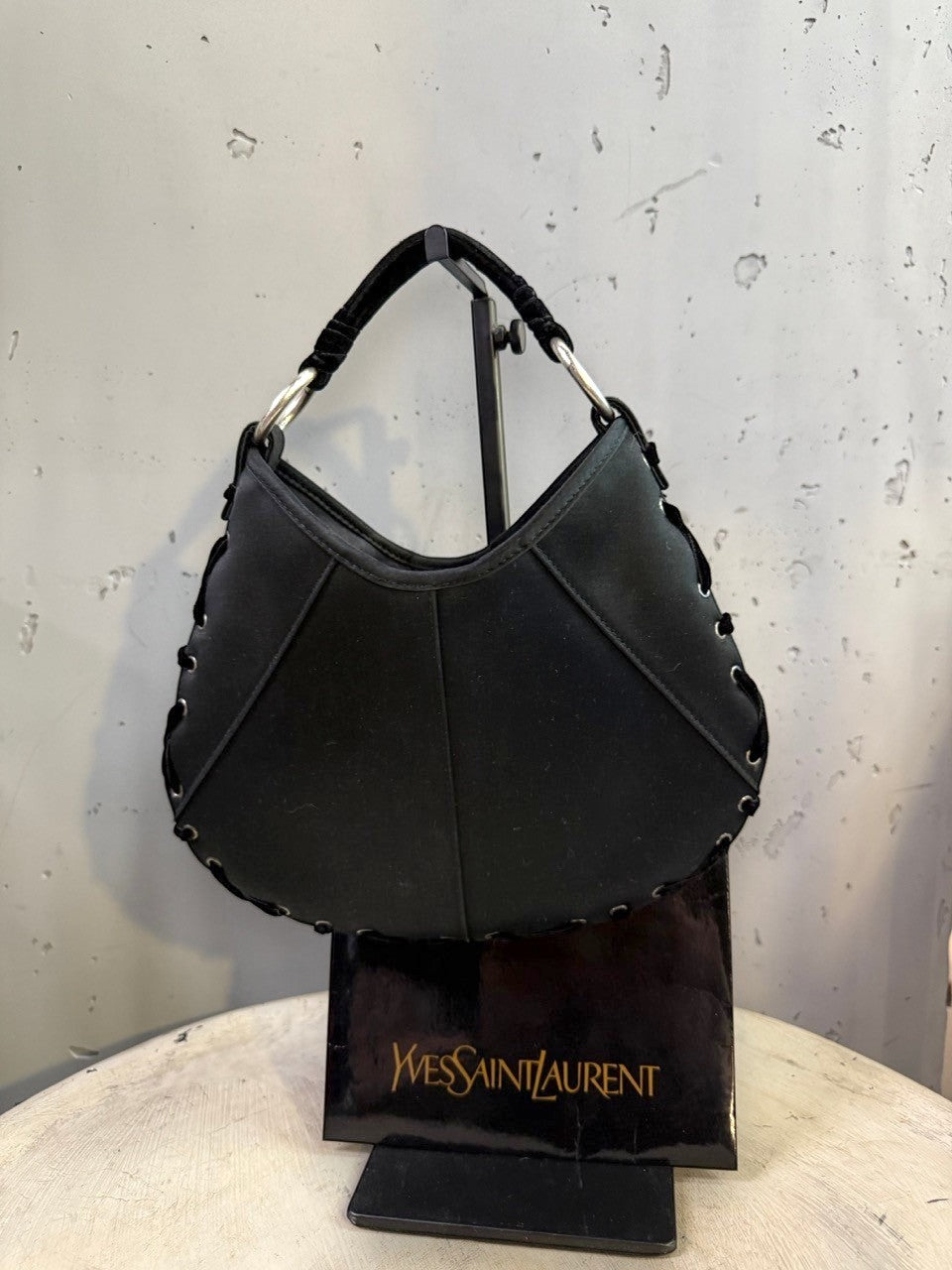 BERLIN VINTAGE CORNER black hobo shoulder bag with crescent moon shape, lacing detail, silver hardware, and velvet strap.