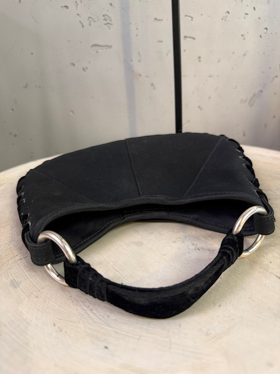 BERLIN VINTAGE CORNER black hobo shoulder bag with crescent moon shape, lacing detail, silver O-rings, and velvet strap.