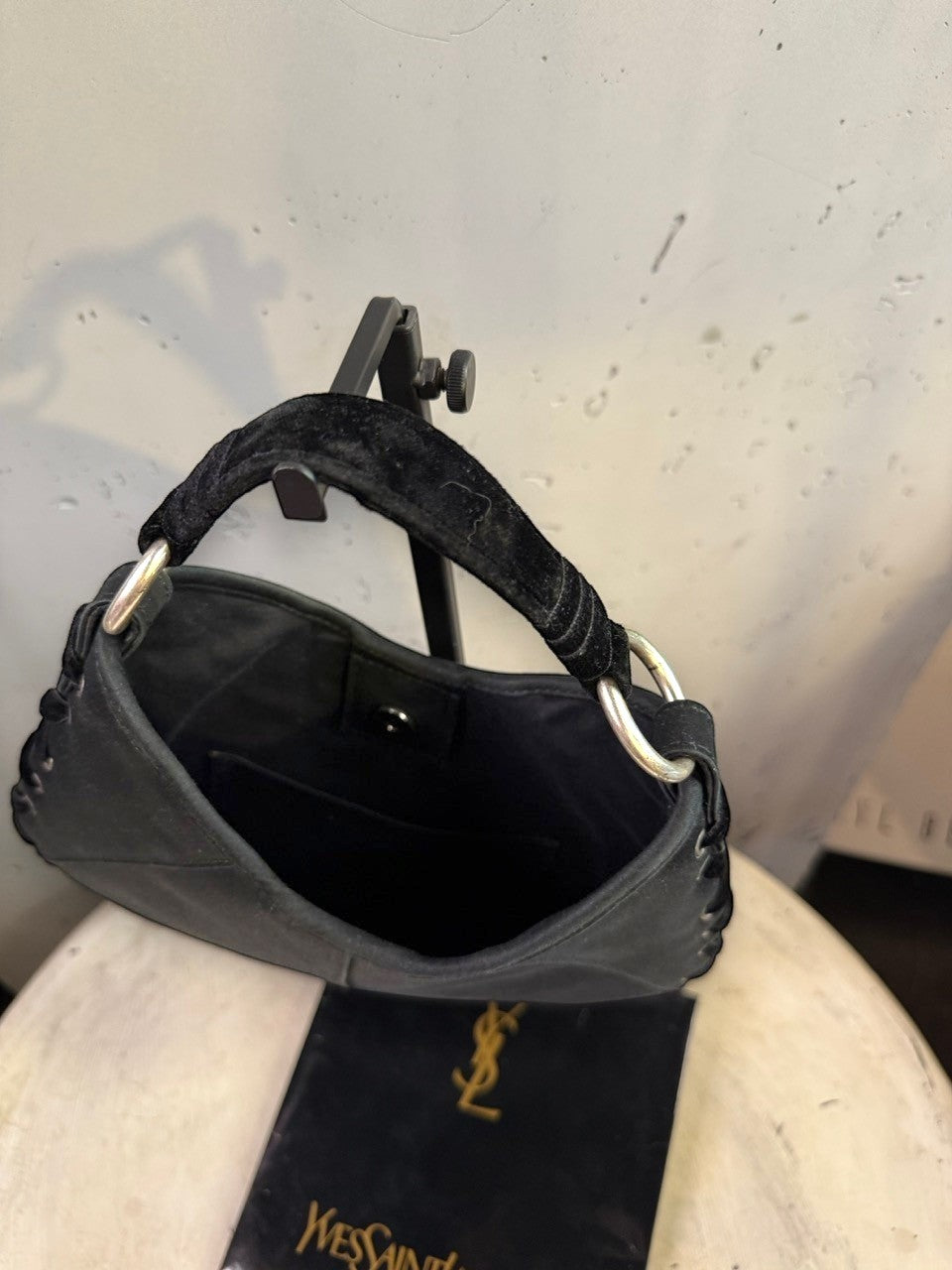 BERLIN VINTAGE CORNER black hobo shoulder bag with velvet strap and silver O-ring accents. Features lacing detail.