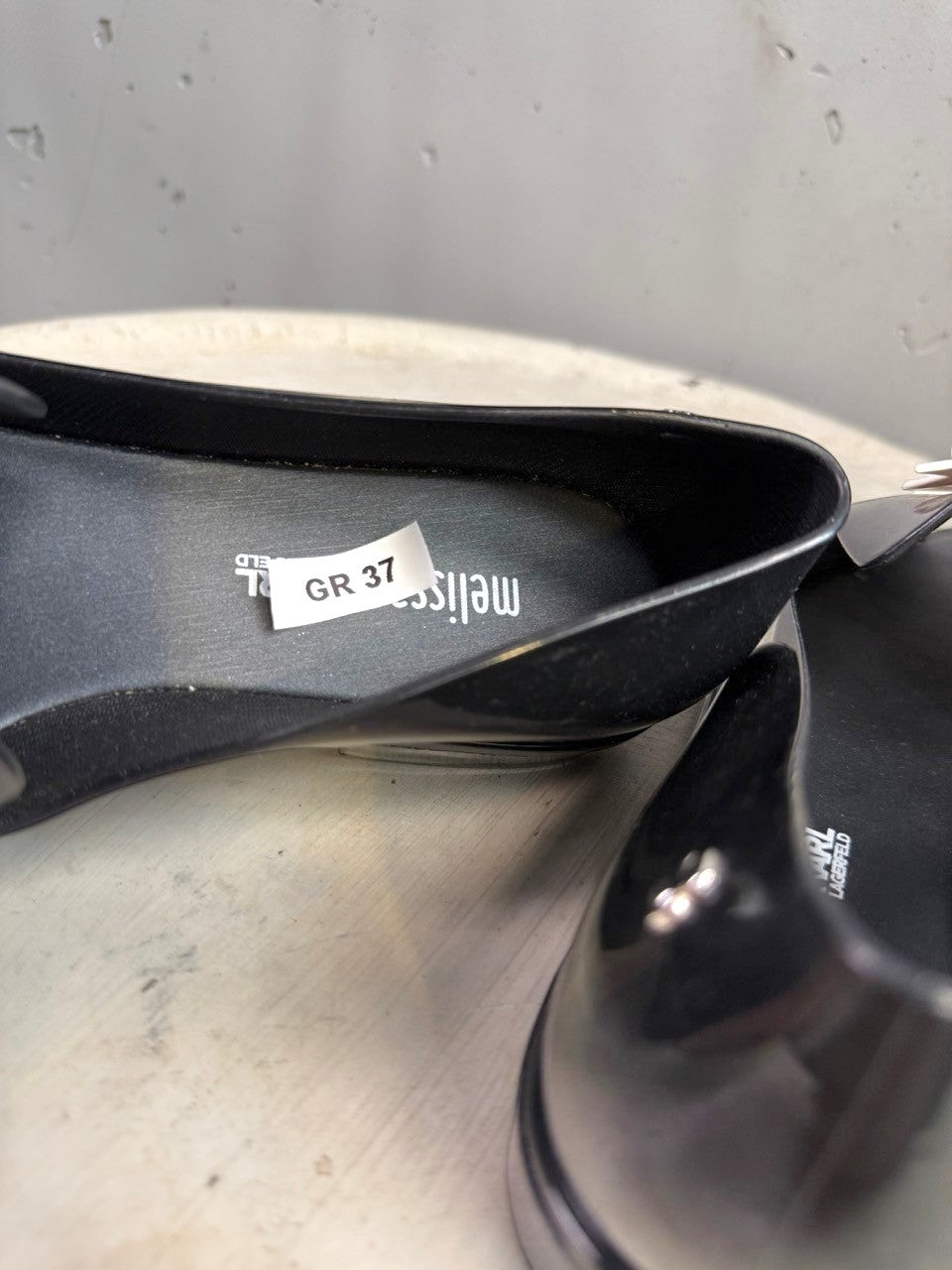 BERLIN VINTAGE CORNER black PVC jelly loafers with a peep-toe and double bow accent.