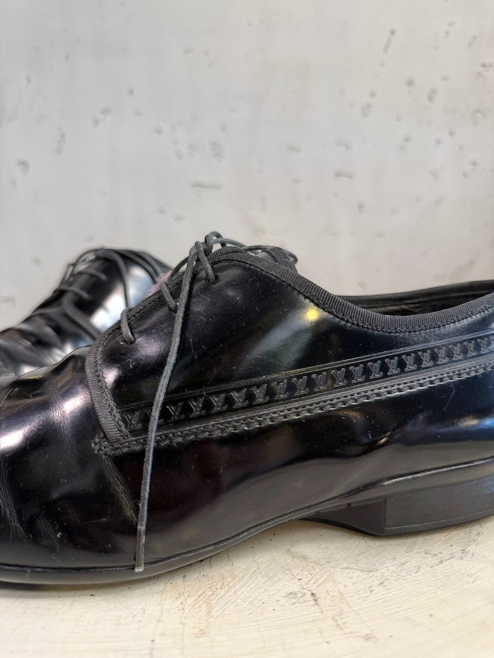 BERLIN VINTAGE CORNER black polished leather lace-up dress shoes with subtle monogram detail.
