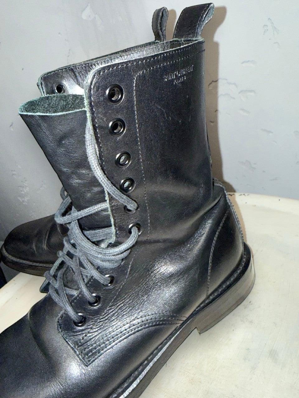 BERLIN VINTAGE CORNER black leather lace-up combat boots with Saint Laurent Paris logo detail.