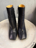 BERLIN VINTAGE CORNER black leather square toe heeled ankle boots with side zipper and tan heel detail.