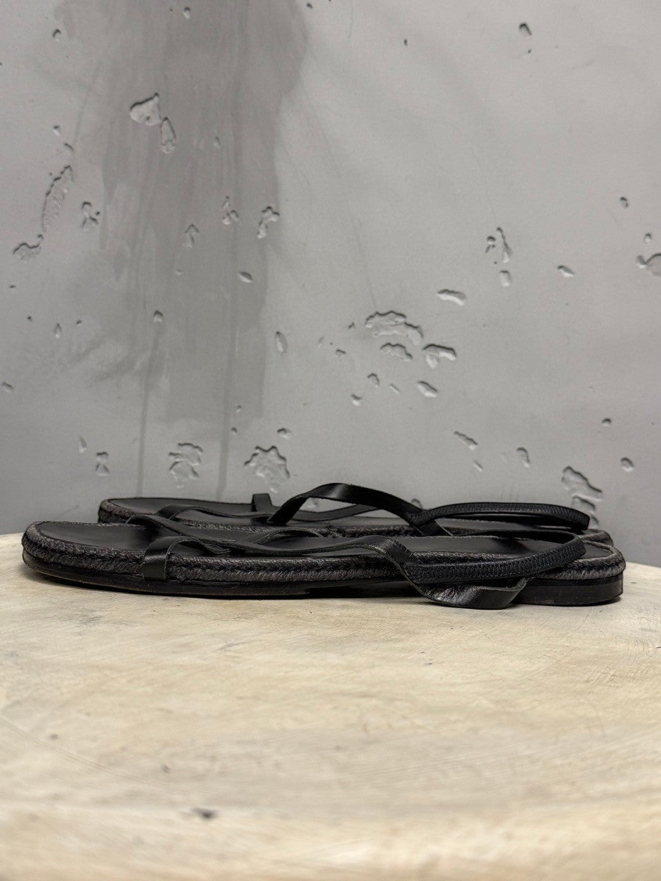 BERLIN VINTAGE CORNER black leather strappy flat sandals with jute-wrapped midsole and delicate crisscross straps.