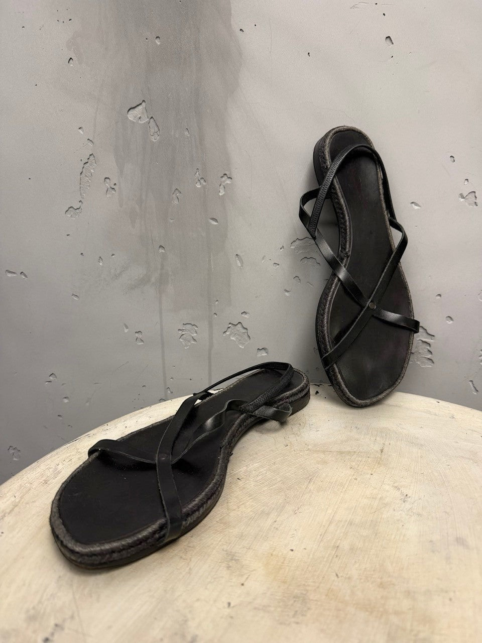 BERLIN VINTAGE CORNER black leather strappy flat sandals with jute-wrapped midsole.