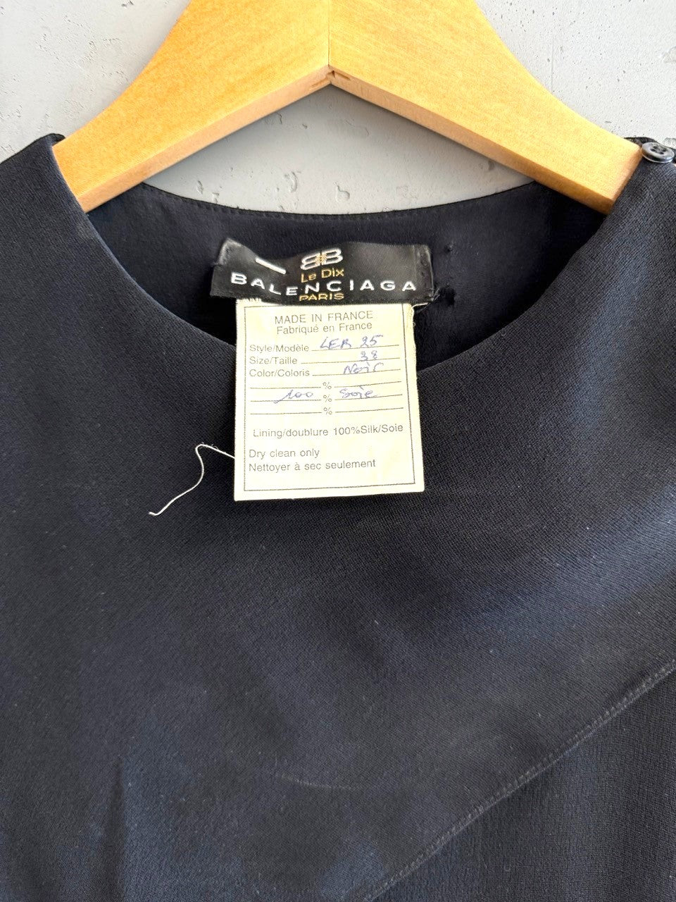 BERLIN VINTAGE CORNER black midi dress with asymmetrical neckline and sheer sleeves. Features subtle button details.