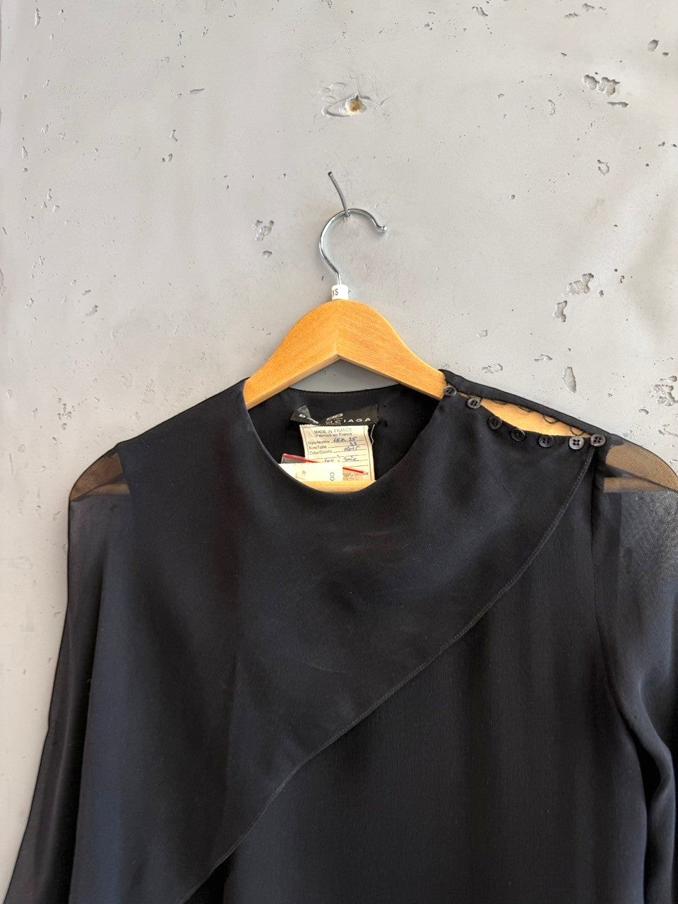 BERLIN VINTAGE CORNER black midi dress with asymmetrical neckline, sheer long sleeves, and button details.
