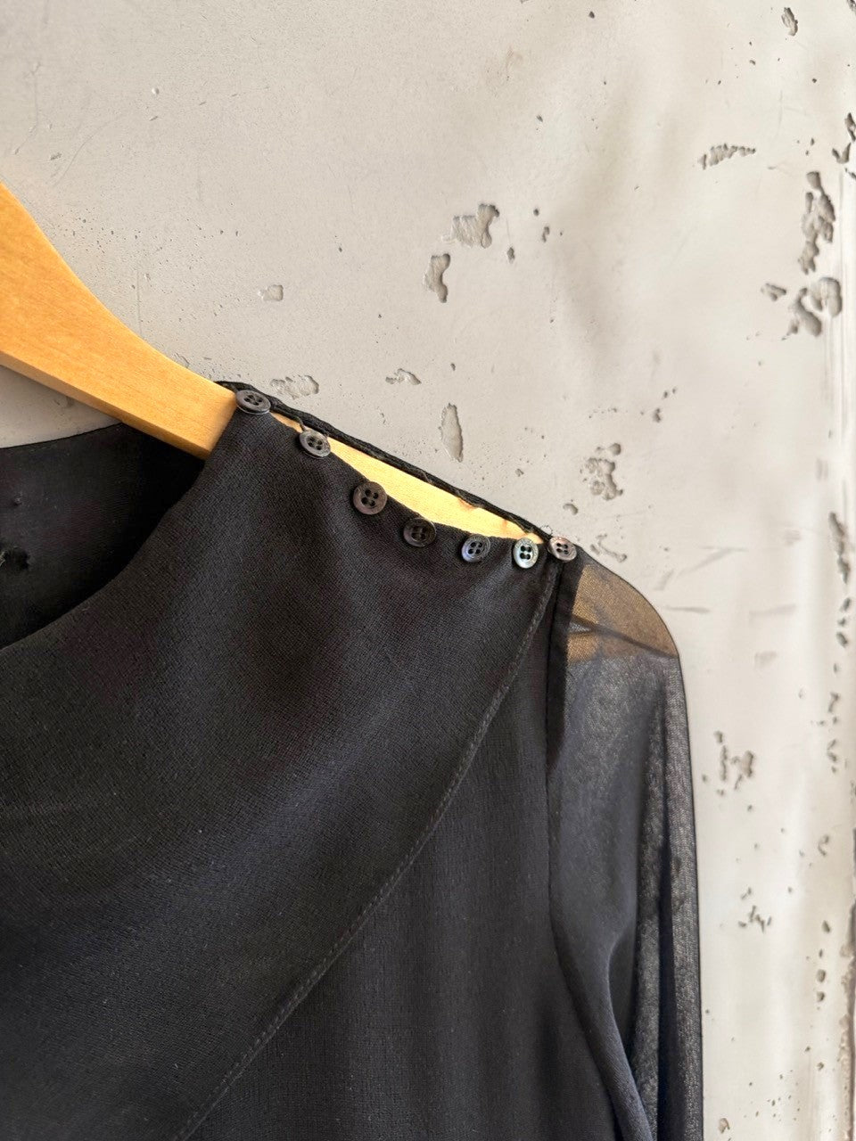 BERLIN VINTAGE CORNER black midi dress with sheer sleeves, asymmetrical neckline, and button details.