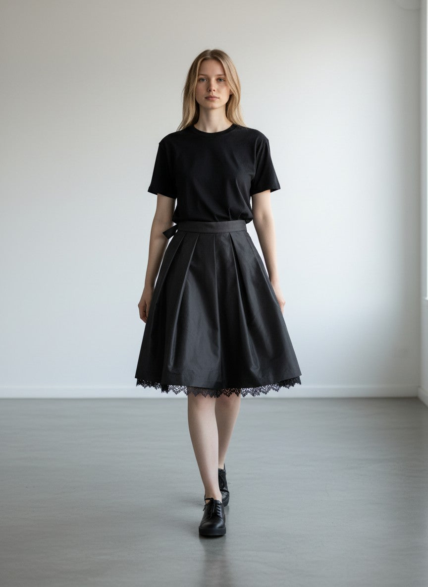 BERLIN VINTAGE CORNER black midi skirt with pleats and lace trim, satin-like fabric, A-line silhouette, tulle layer for volume.