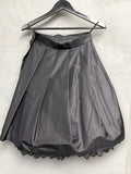 BERLIN VINTAGE CORNER black satin-like midi skirt with pleats and lace trim hem, A-line silhouette.