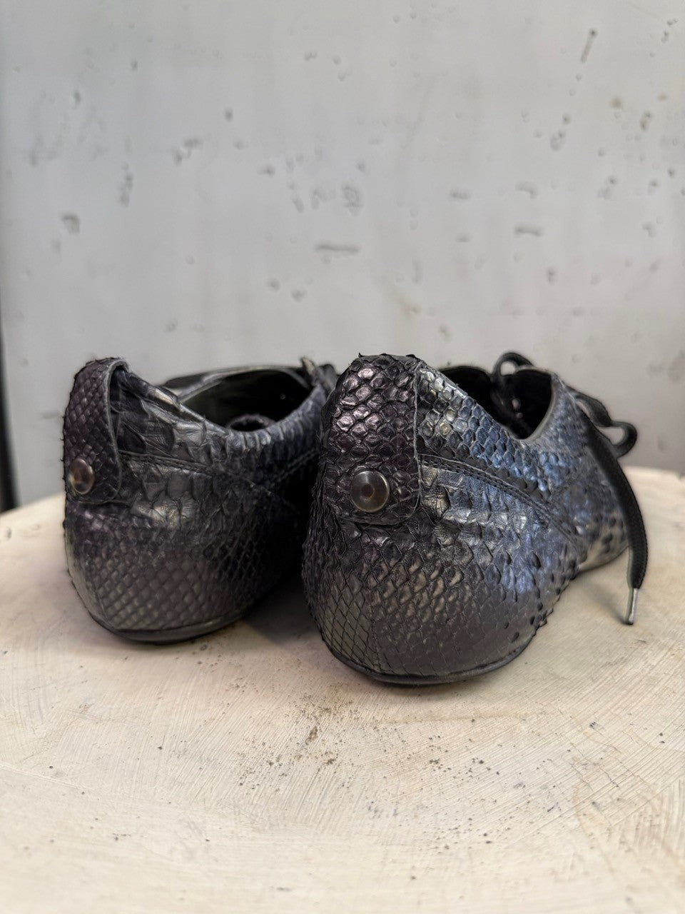 BERLIN VINTAGE CORNER black python leather lace-up sneakers with embossed texture and silver eyelets.