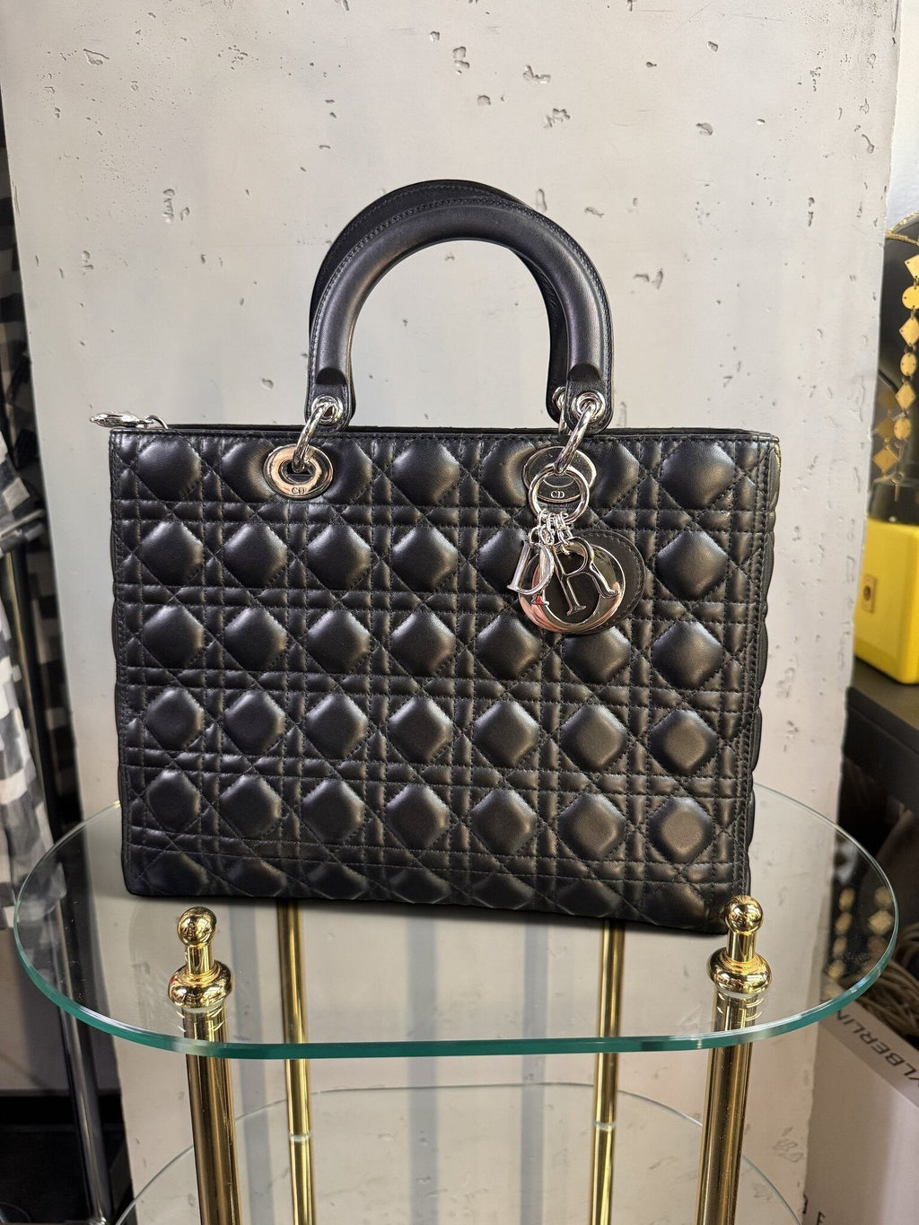 BERLIN VINTAGE CORNER black quilted leather handbag with cannage stitching, silver hardware, and dangling logo charms.