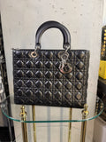 BERLIN VINTAGE CORNER black quilted leather handbag with cannage stitching, silver hardware, and dangling logo charms.