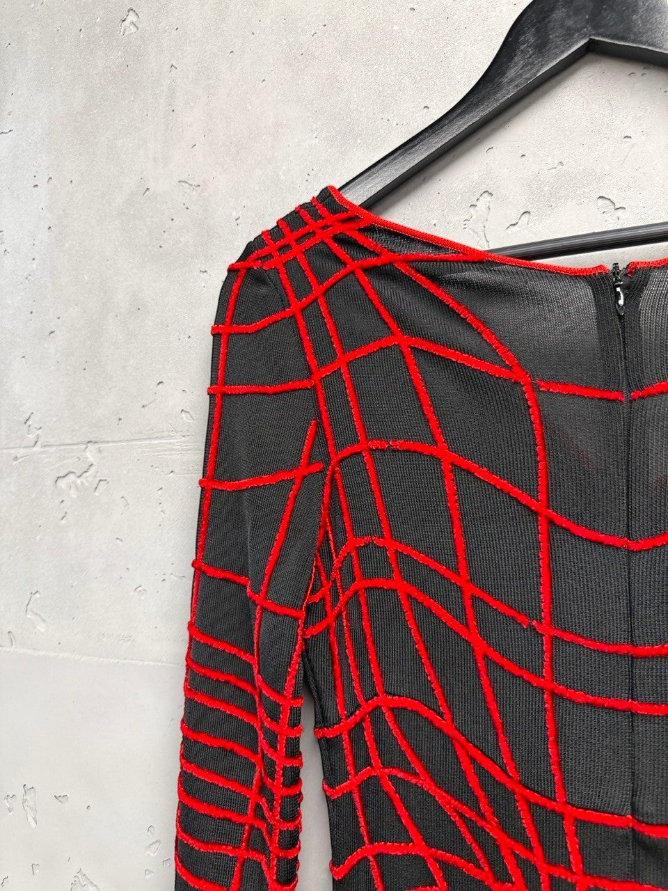 BERLIN VINTAGE CORNER black knit midi dress with red geometric grid pattern, long sleeves, and V-neckline.