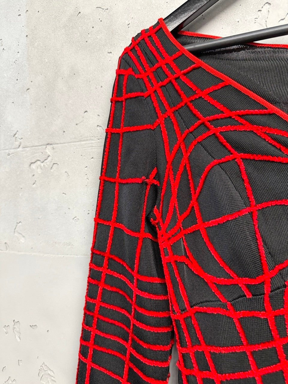BERLIN VINTAGE CORNER black knit midi dress with red geometric grid pattern, V-neckline and long sleeves.