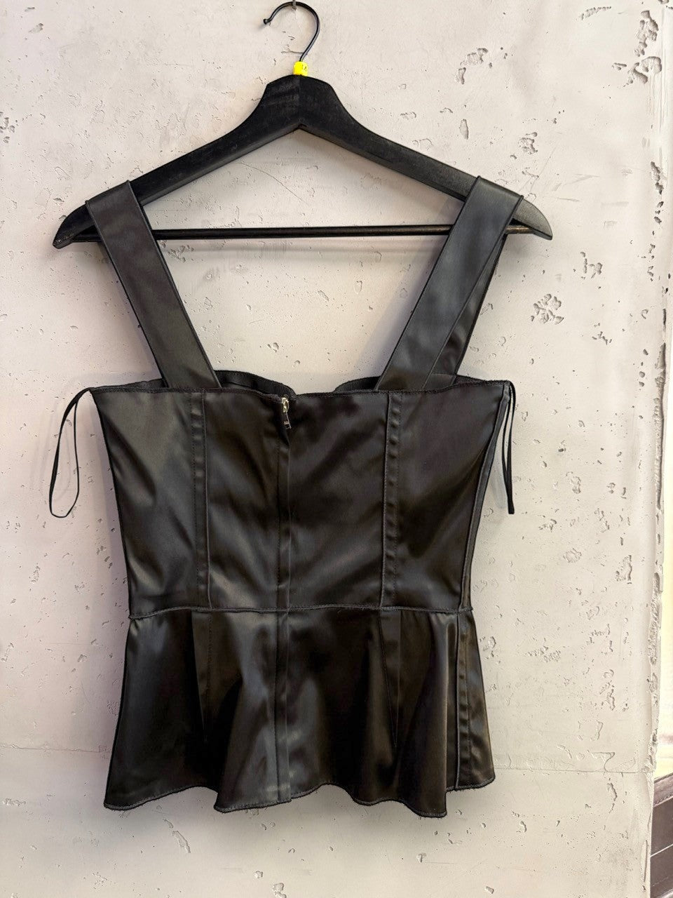 BERLIN VINTAGE CORNER black satin corset tank top with wide straps and structured seam detailing on a hanger.